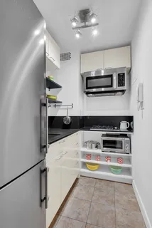 a kitchen with stainless steel appliances a stove a microwave and cabinets