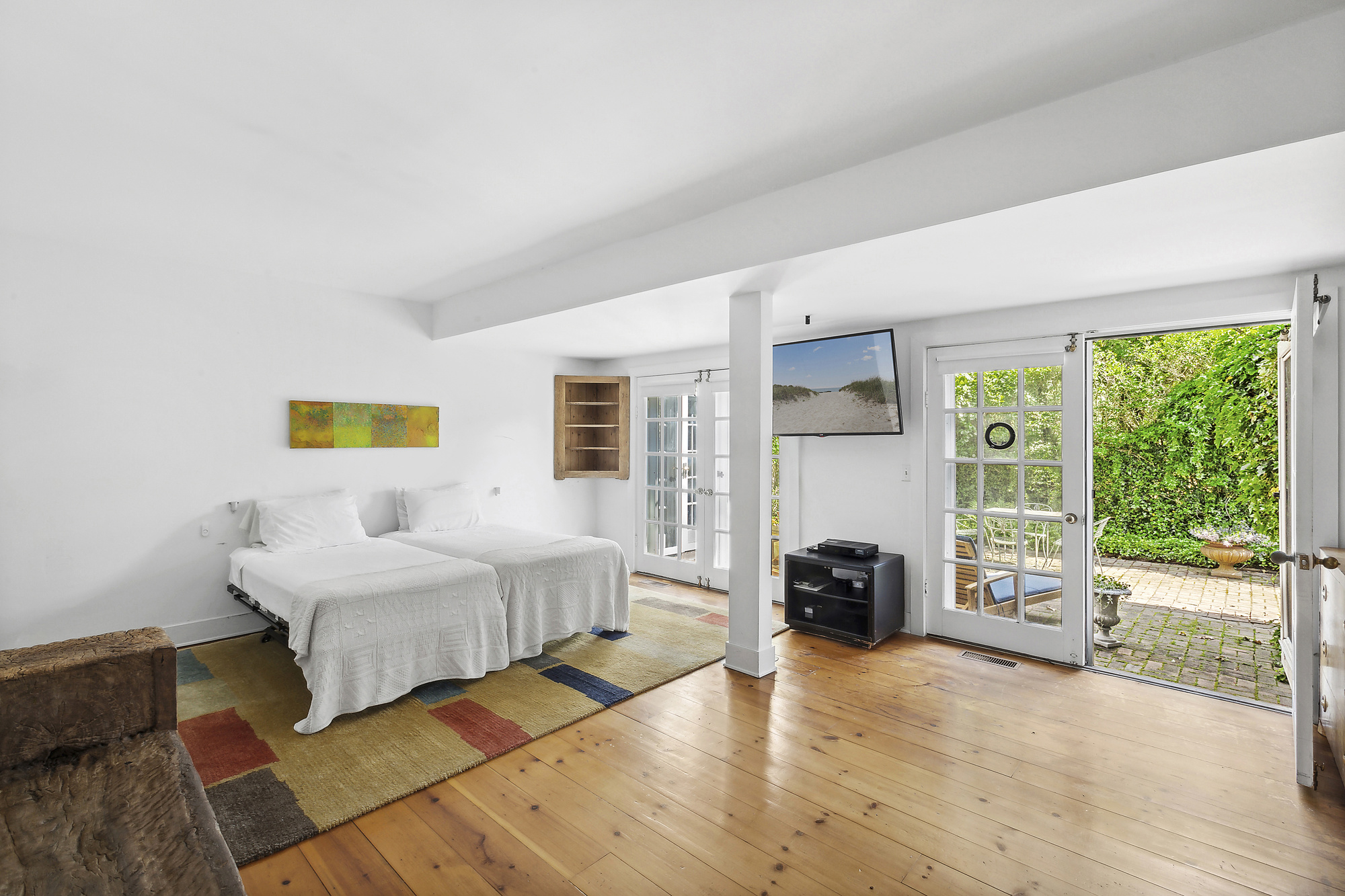 488 Ocean Road Bridgehampton, NY 11932 - Photo 13 of 21 a bedroom with a bed and a couch