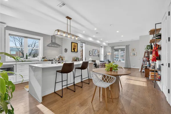 a view of a dining room with furniture and wooden floor