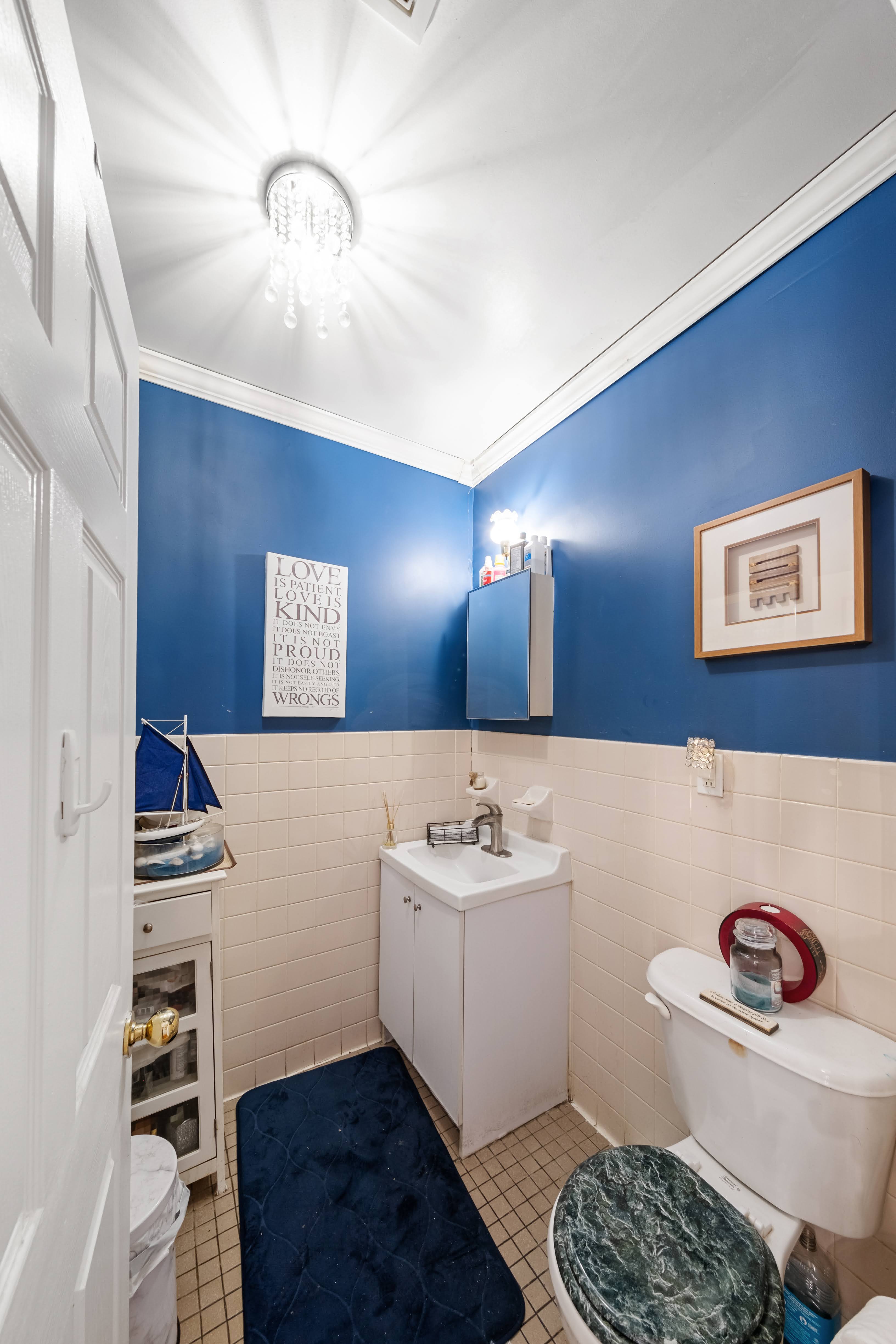 275 Van Buren Street Brooklyn, NY 11221 - Photo 8 of 33 a bathroom with a sink toilet and a mirror