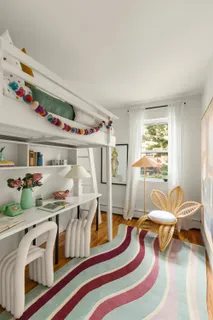 a bedroom with furniture and a wooden floor