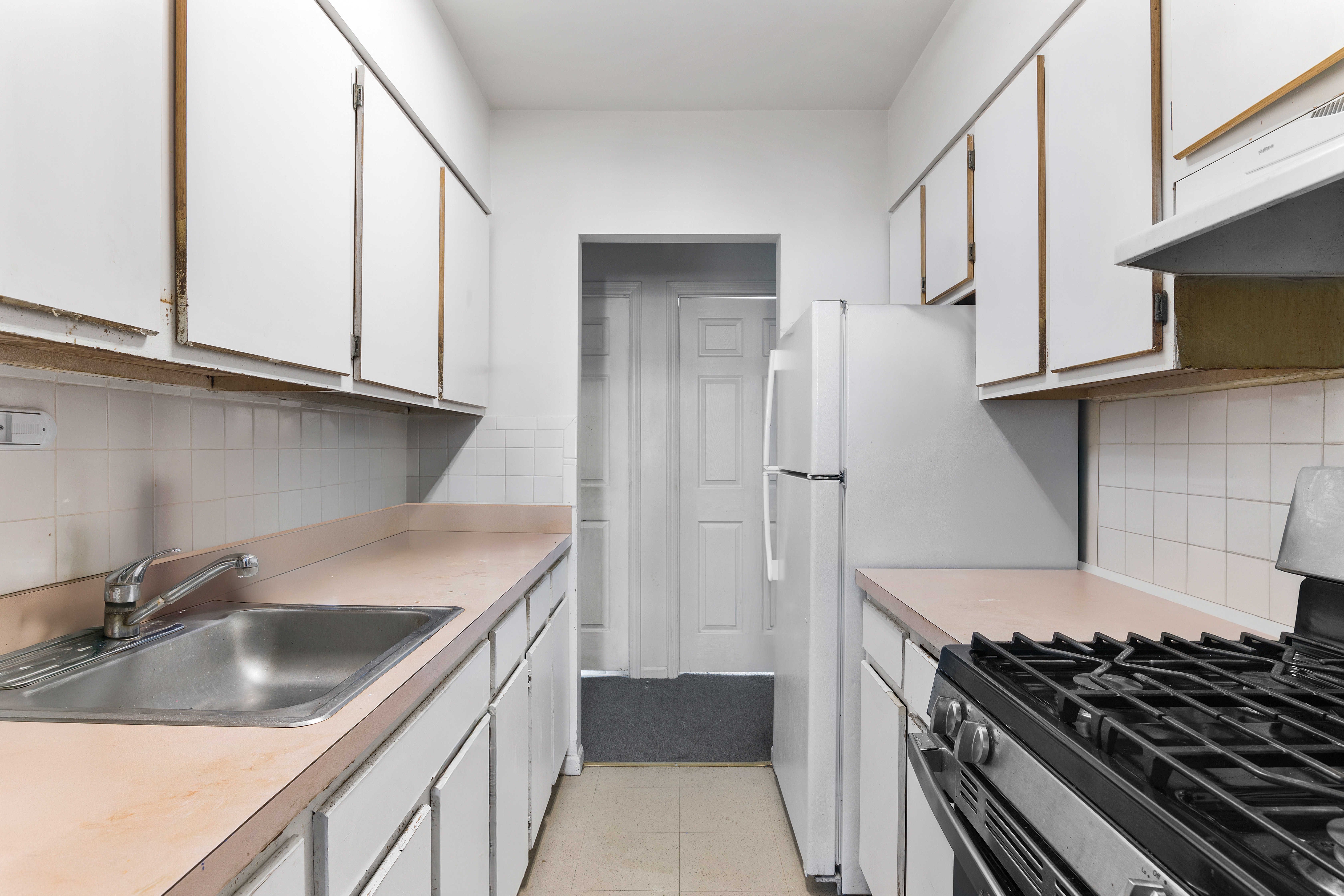 364 Chauncey Street Brooklyn, NY 11233 - Photo 14 of 17 a kitchen that has a sink and a stove