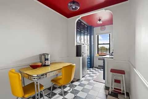 a dining room with a table and chairs