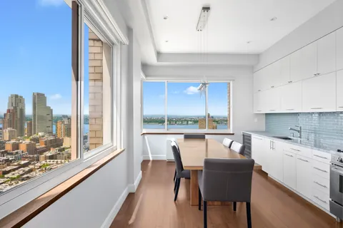 a dining room with furniture a rug and a large window