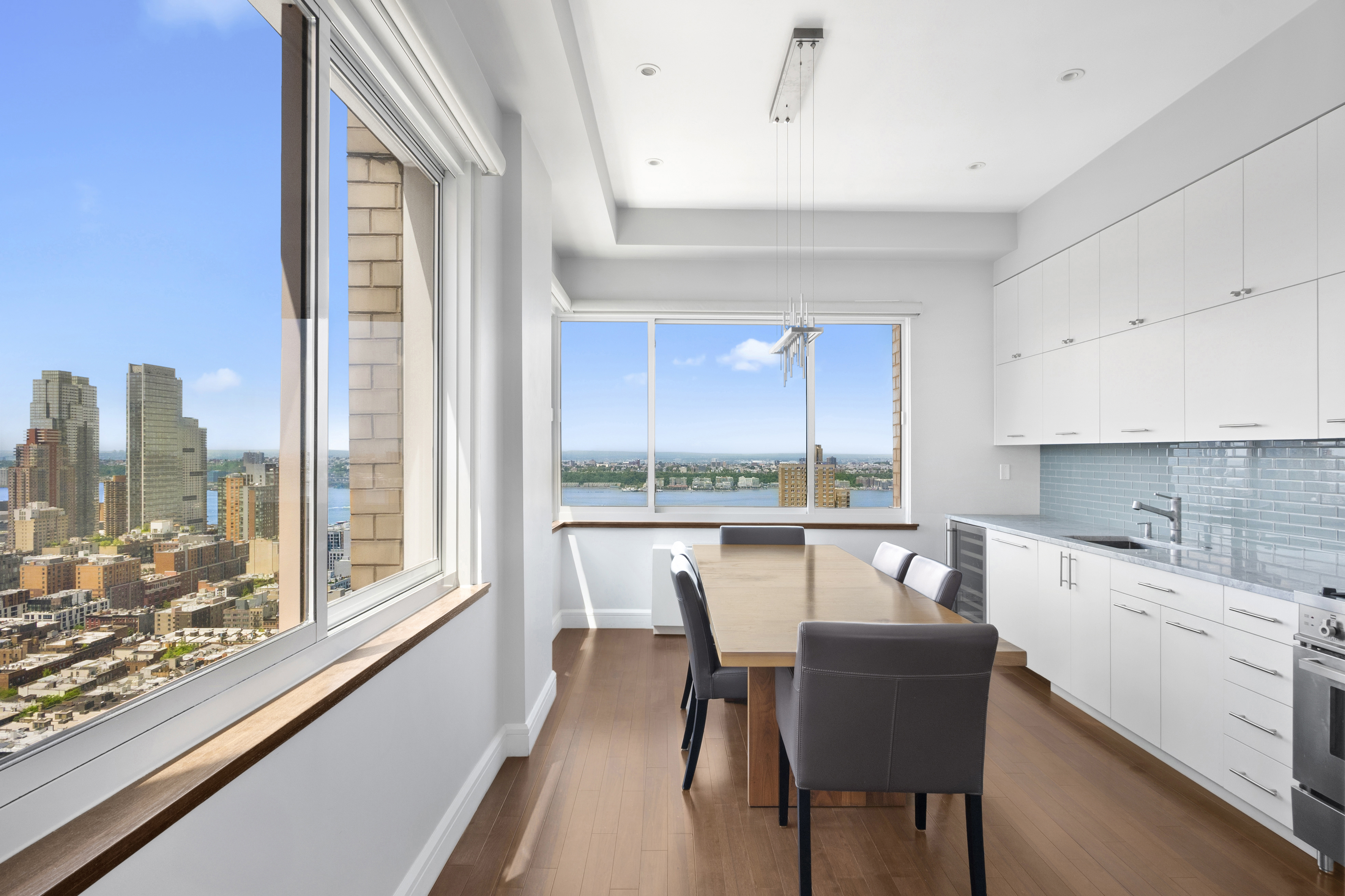 350 West 50th Street, Unit PH4B Manhattan, NY 10019 - Photo 2 of 18 a dining room with furniture a rug and a large window