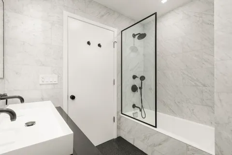 a bathroom with a tub and shower