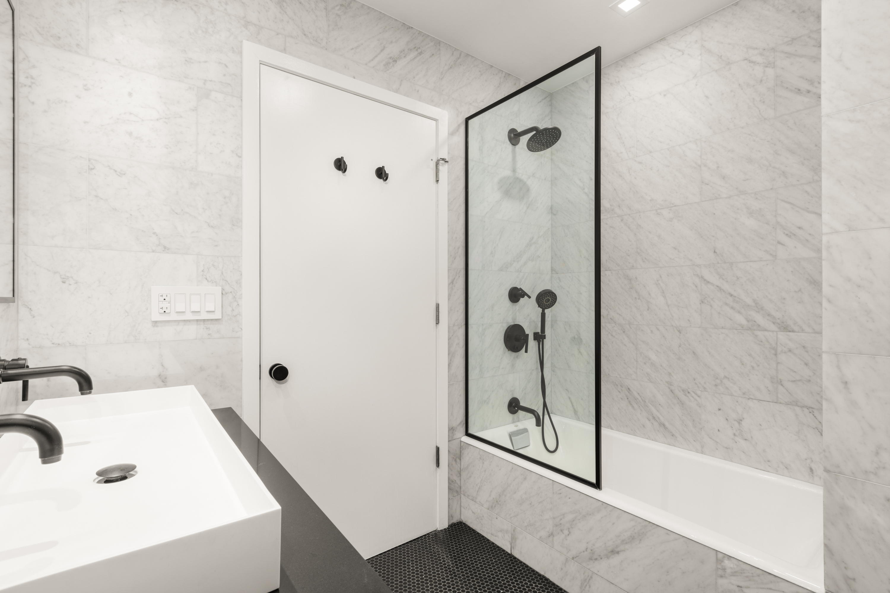 112 Hudson Street, Unit 3 Manhattan, NY 10013 - Photo 6 of 11 a bathroom with a tub and shower