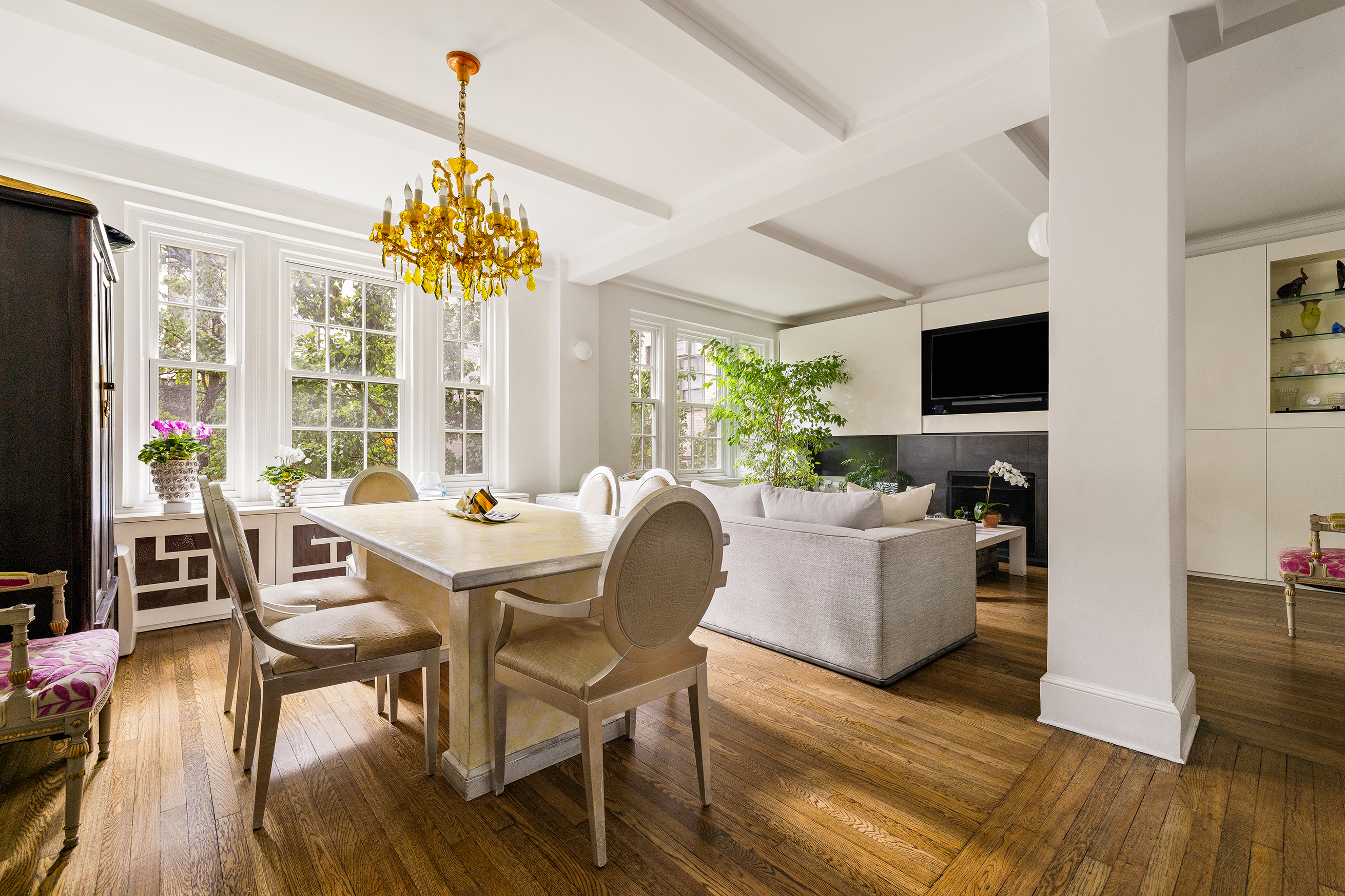 108 East 82nd Street, Unit 4D Manhattan, NY 10028 - Photo 3 of 10 a dining room with furniture a chandelier and wooden floor