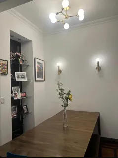 a view of a livingroom with a dinning table and chandelier