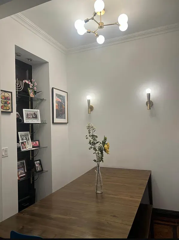a view of a livingroom with a dinning table and chandelier