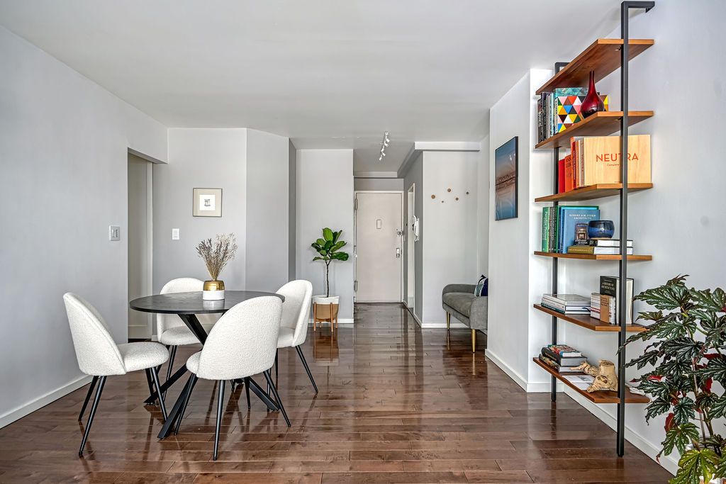 a view of a dining room with furniture and a potted plant