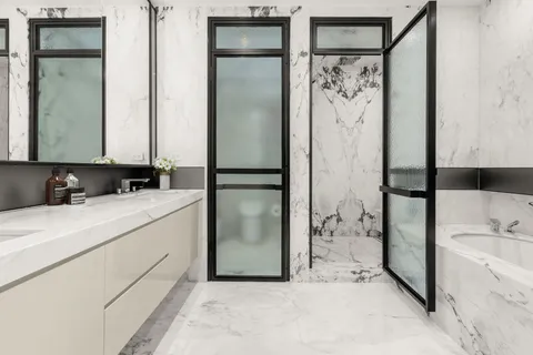 a bathroom with a bathtub and a double vanity sink