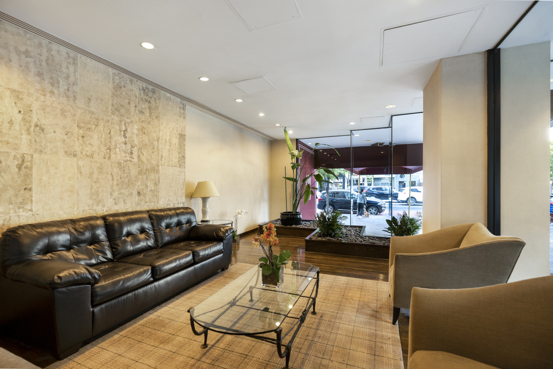 400 East 70th Street, Unit 1008 Manhattan, NY 10021 - Photo 11 of 15 a living room with furniture and a large window