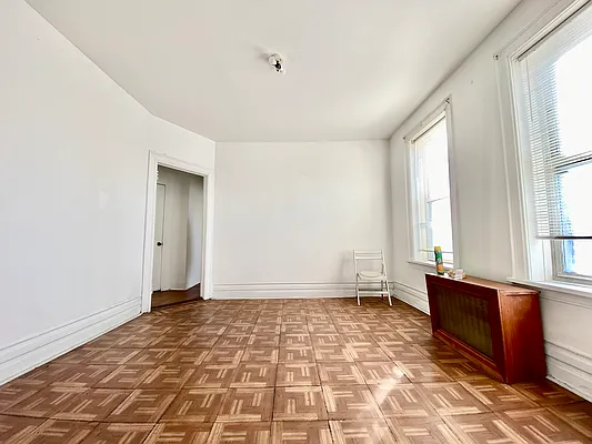 6825 7th Avenue, Unit 2 Brooklyn, NY 11220 - Photo 2 of 9 a view of an empty room and window