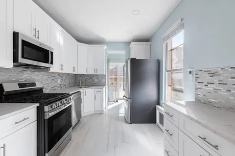 a kitchen with stainless steel appliances a refrigerator stove microwave and sink