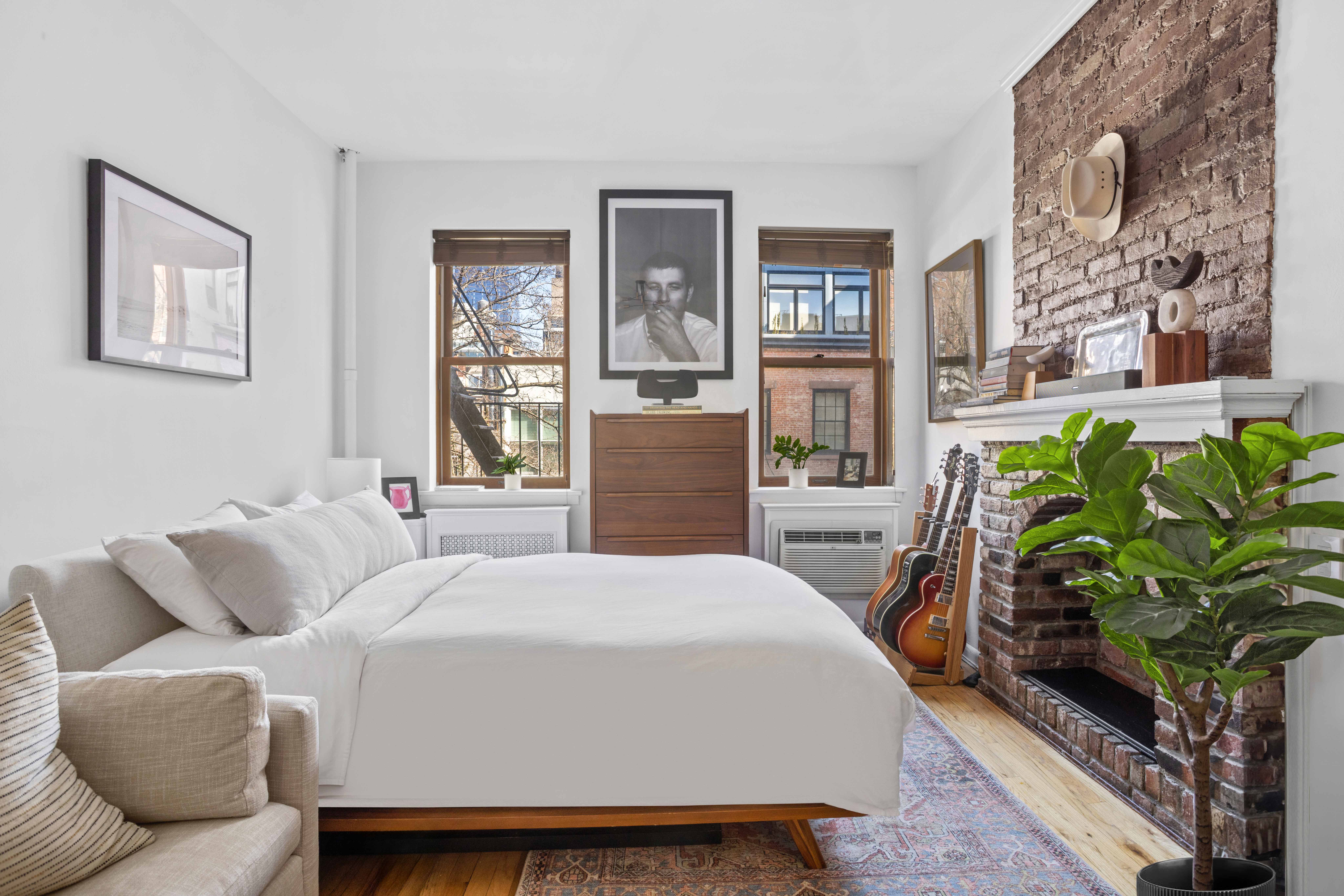 a bedroom with furniture and a potted plant