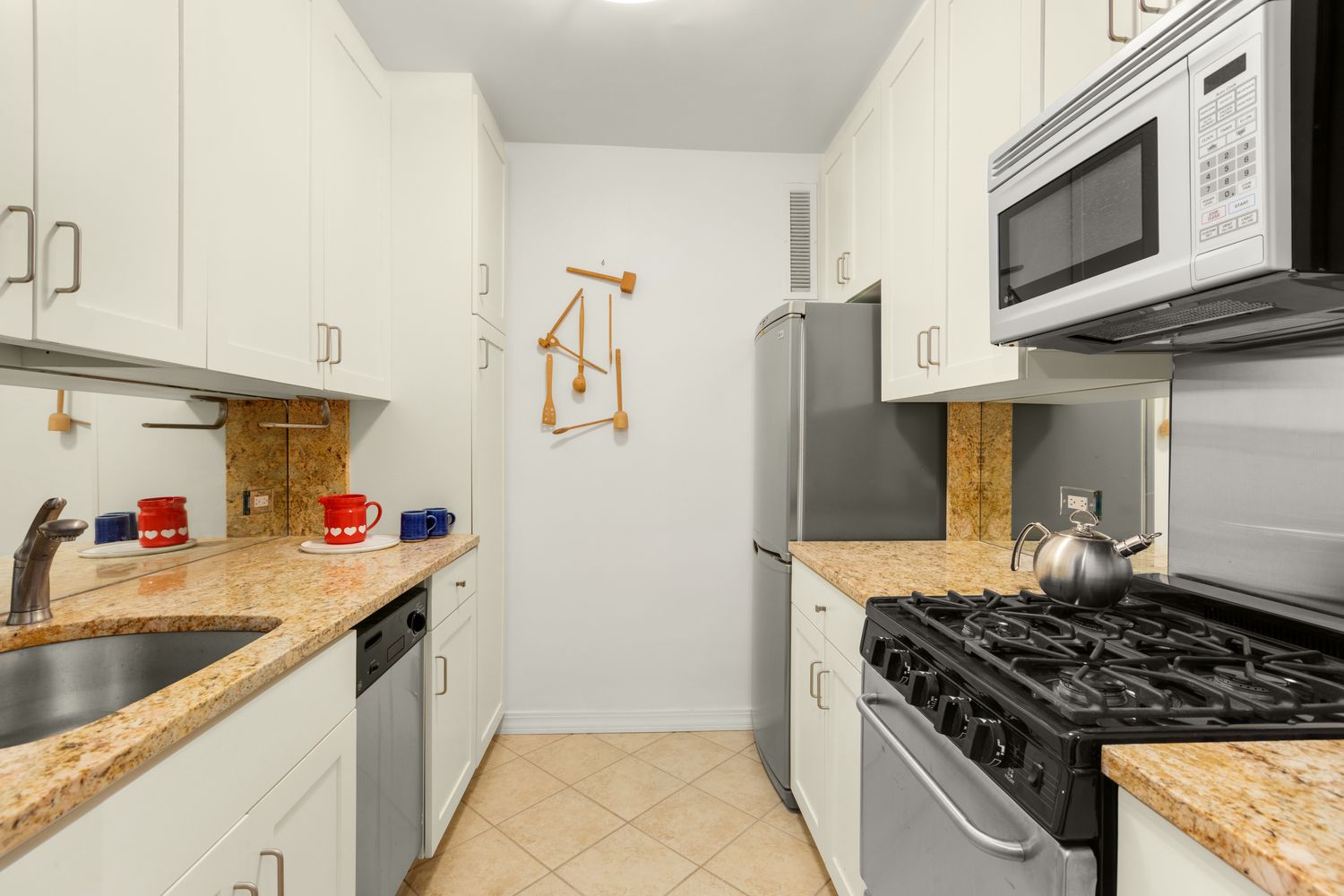 a kitchen with stainless steel appliances granite countertop a stove and a microwave