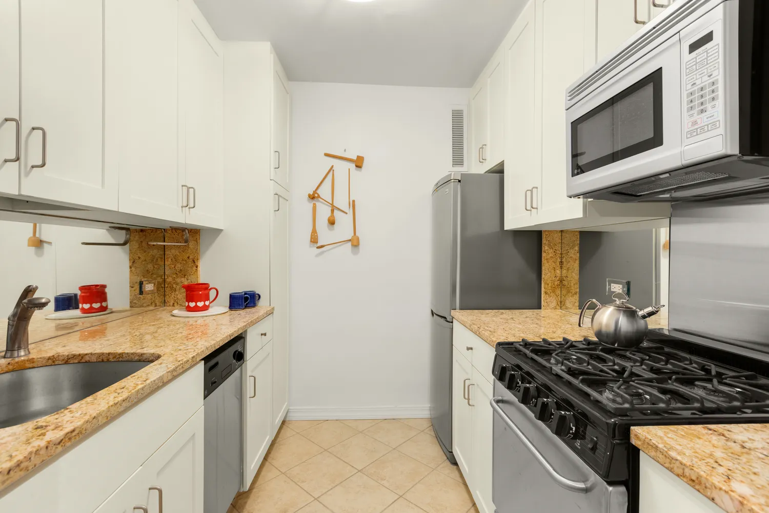 a kitchen with stainless steel appliances granite countertop a stove and a microwave