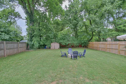 a view of a house with a yard and sitting area