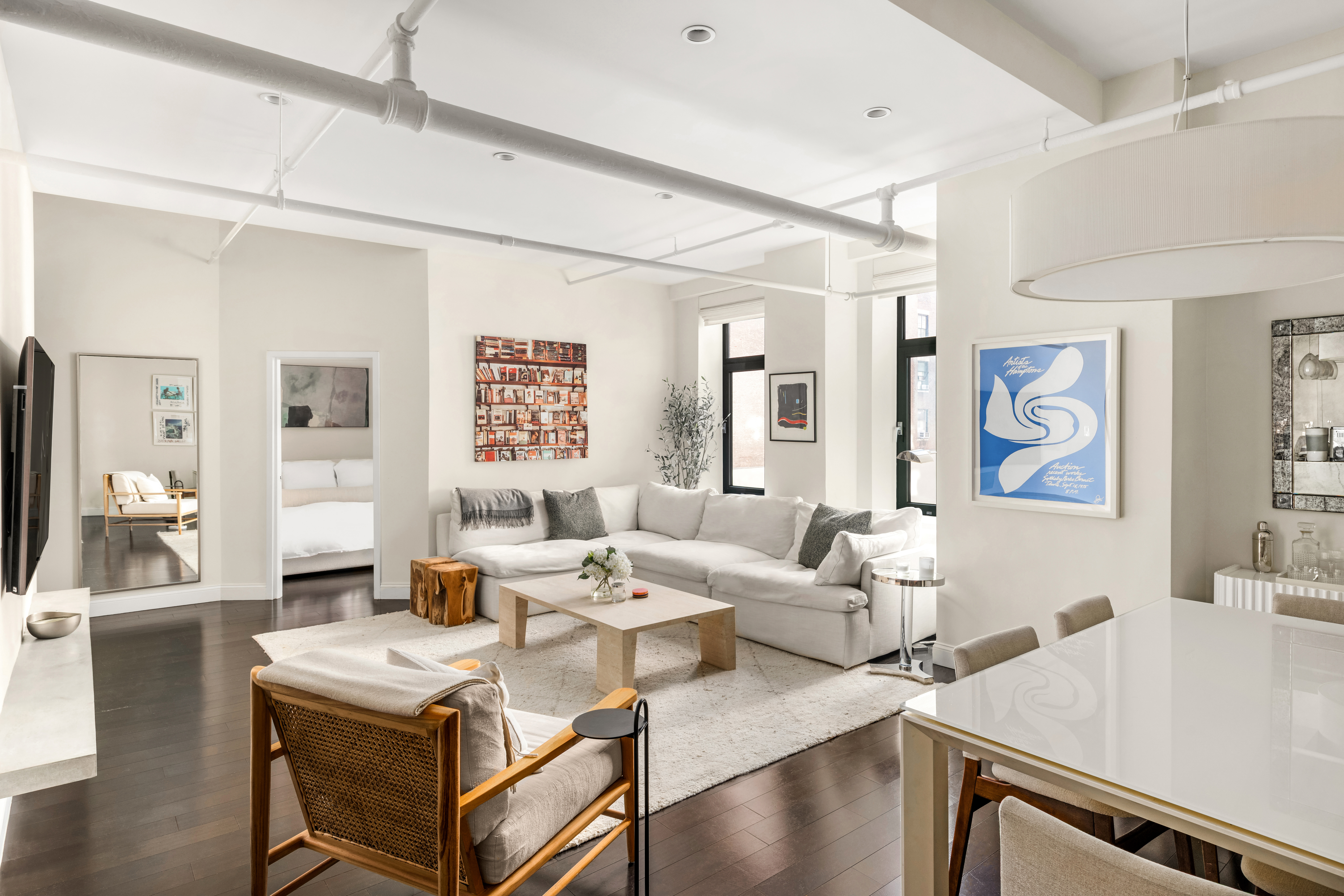 a living room with furniture and wooden floor