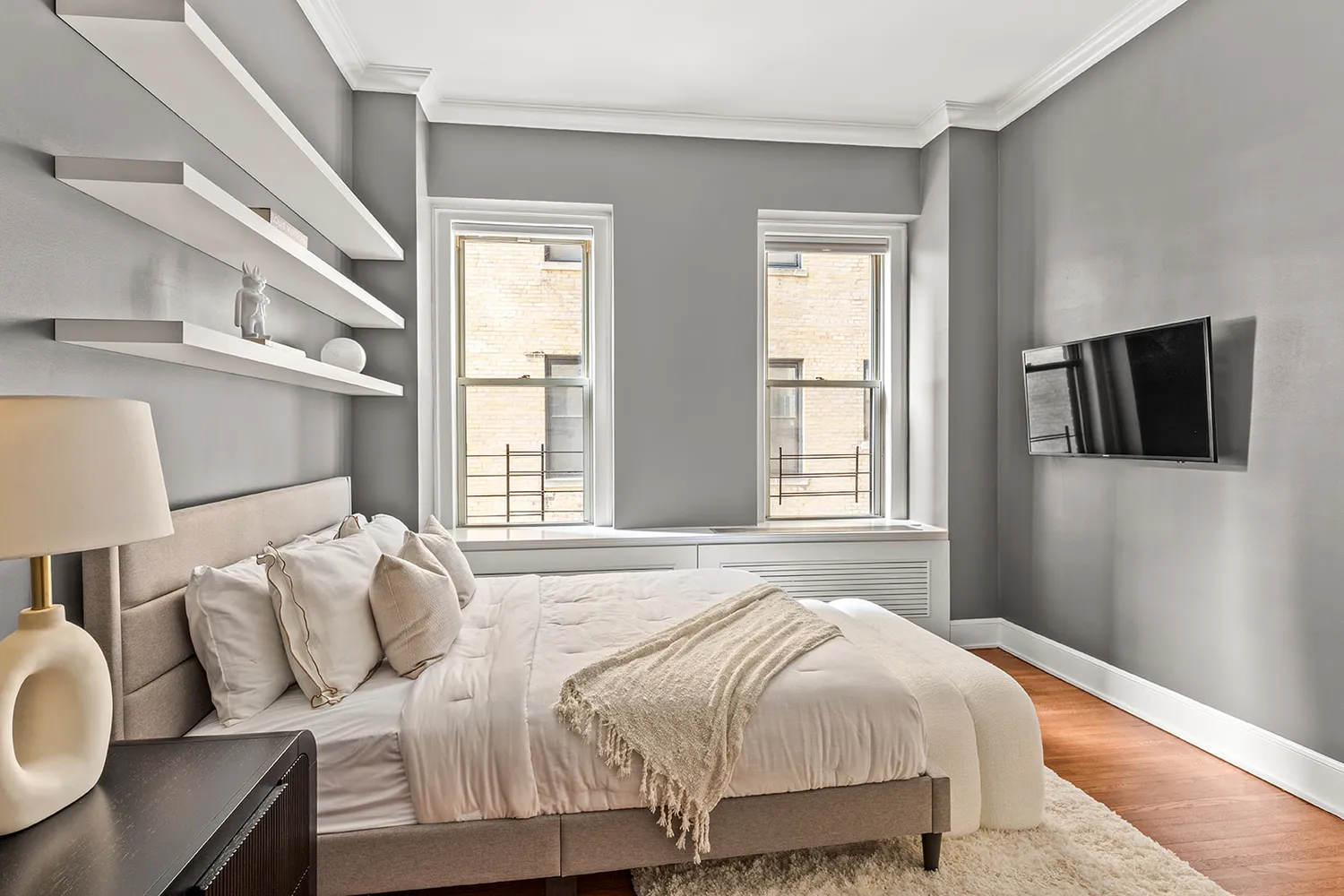 a bedroom with a bed and wooden floor