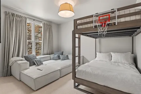 a bedroom with a bed couch and window