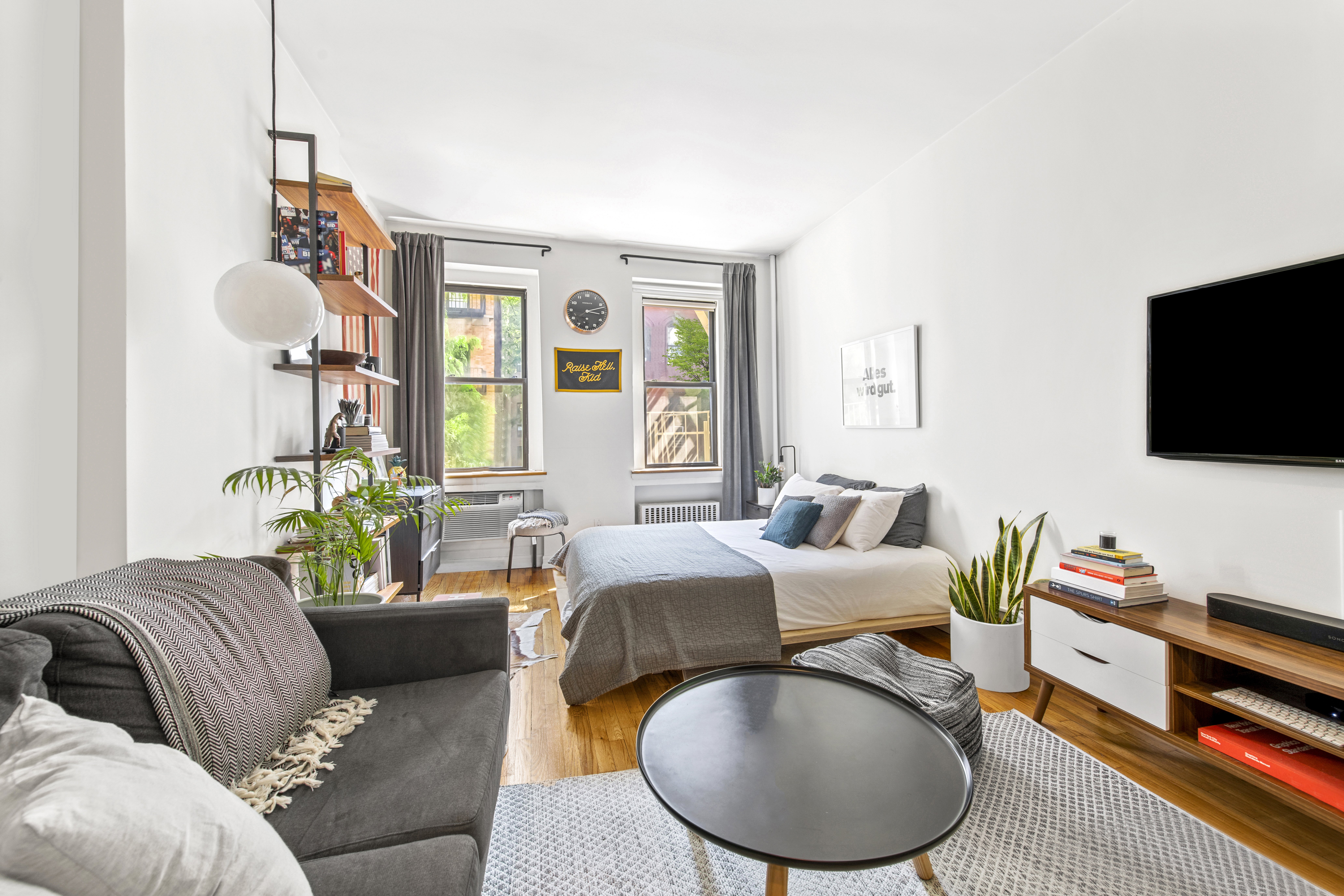 237 East 88th Street, Unit 303 Manhattan, NY 10128 - Photo 2 of 4 a living room with furniture and a flat screen tv