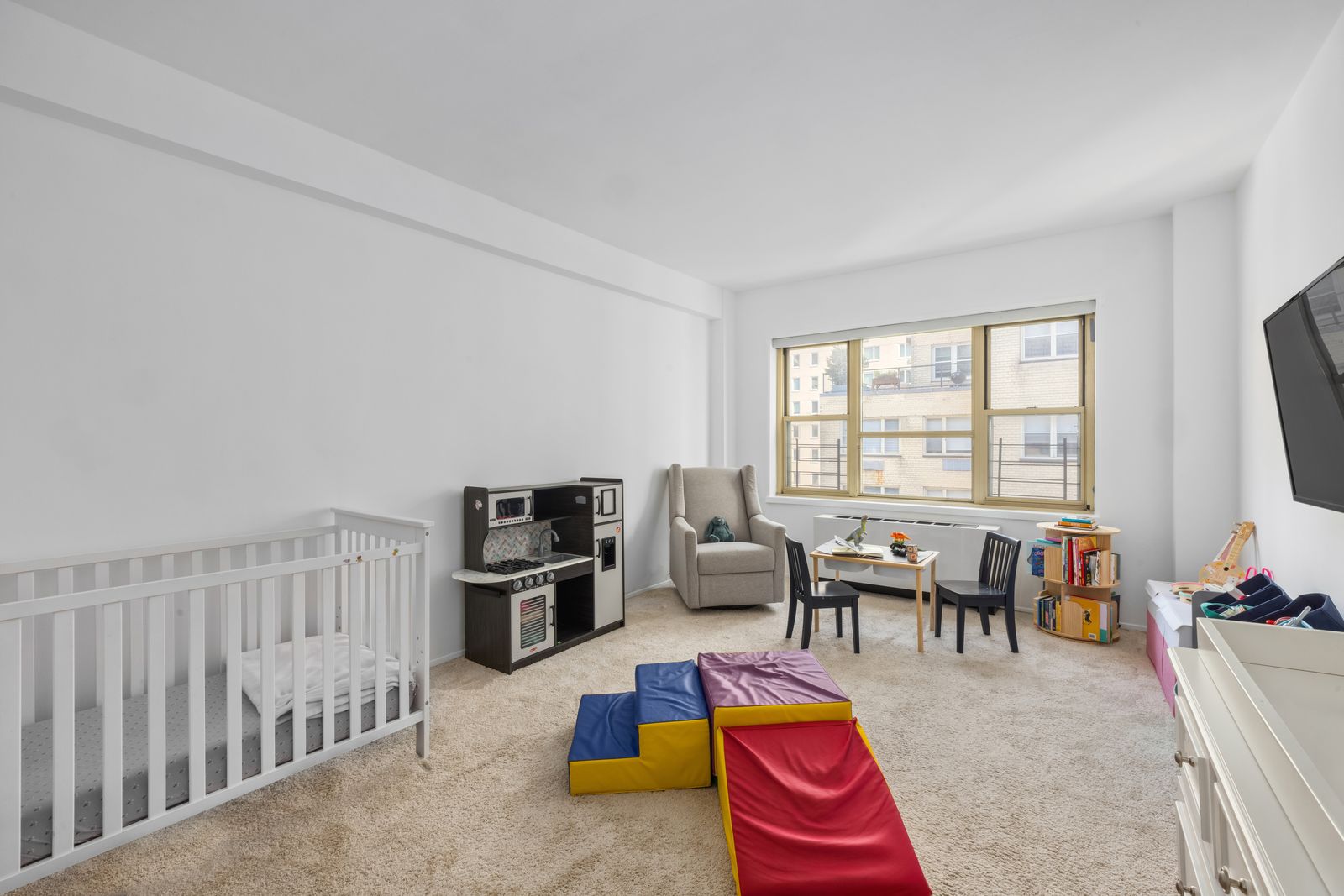 415 East 52nd Street, Unit 9AA Manhattan, NY 10022 - Photo 4 of 10 a living room with furniture and a flat screen tv