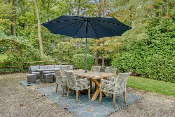 a patio table and chairs under an umbrella