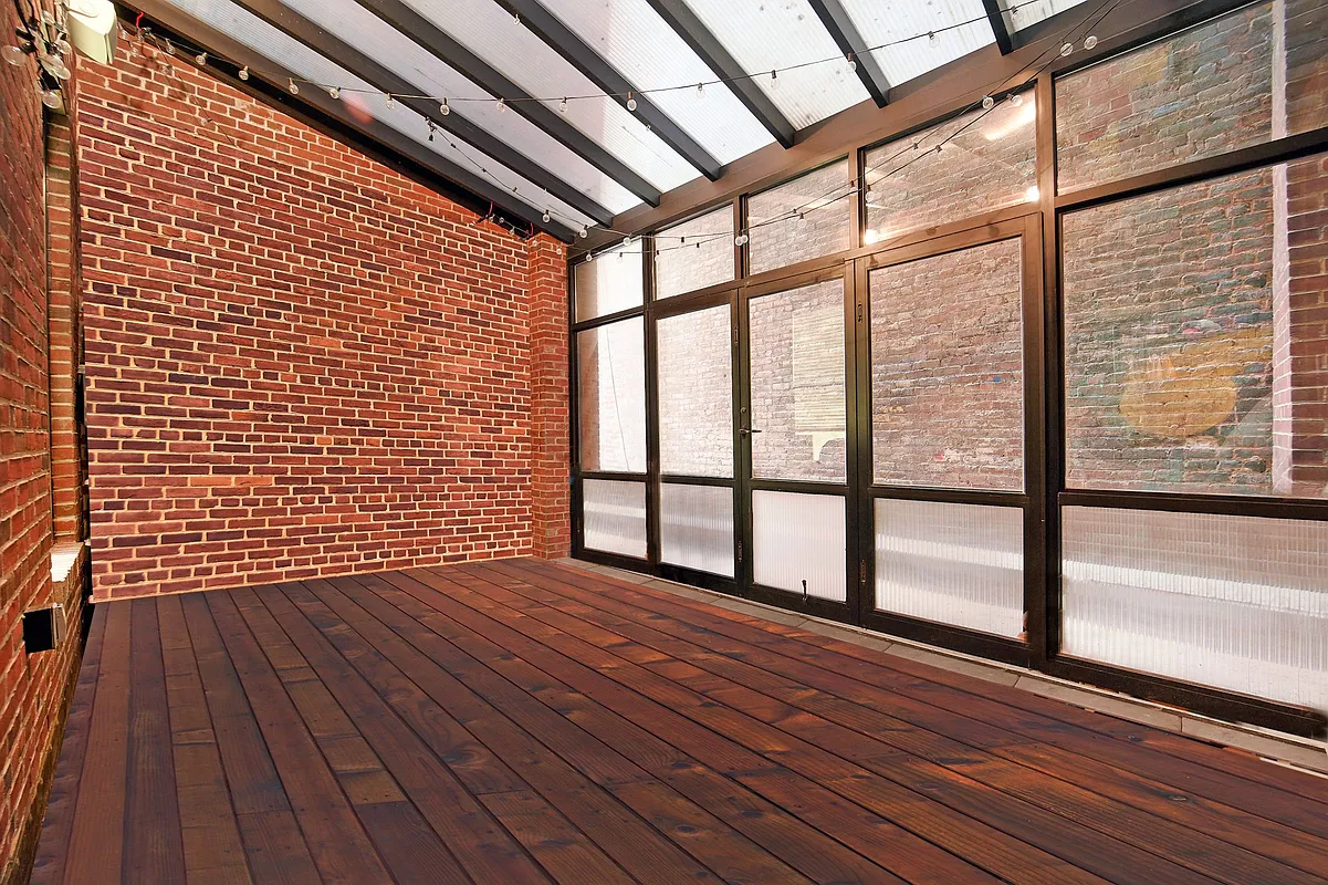 150 Nassau Street, Unit 2A Manhattan, NY 10038 - Photo 15 of 24 a view of an empty room with wooden floor and a window