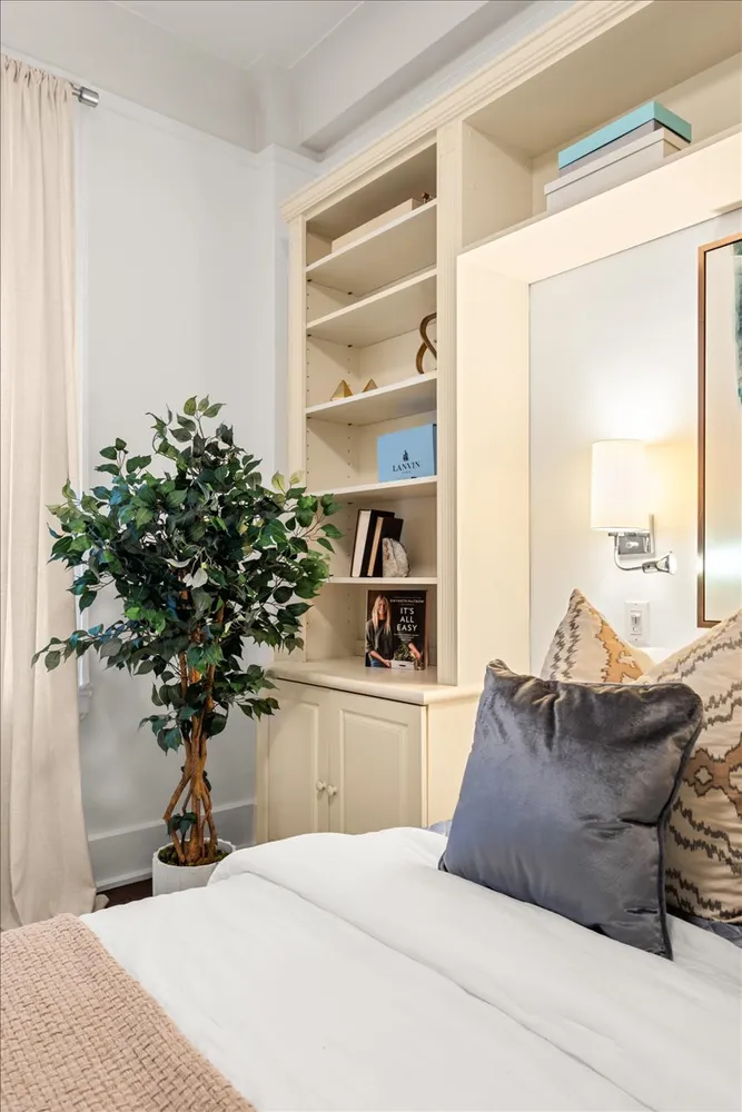 a living room with furniture and potted plant