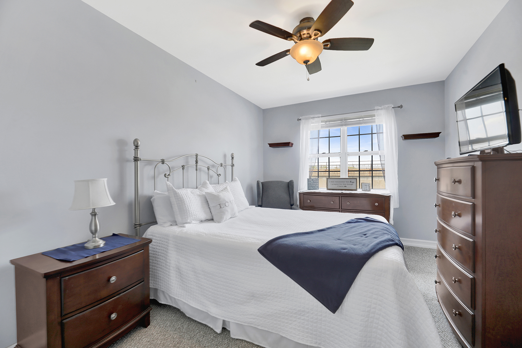 102-20 Rockaway Beach Boulevard, Unit 3C Queens, NY 11694 - Photo 18 of 36 a bedroom with a bed and a tv on the dresser