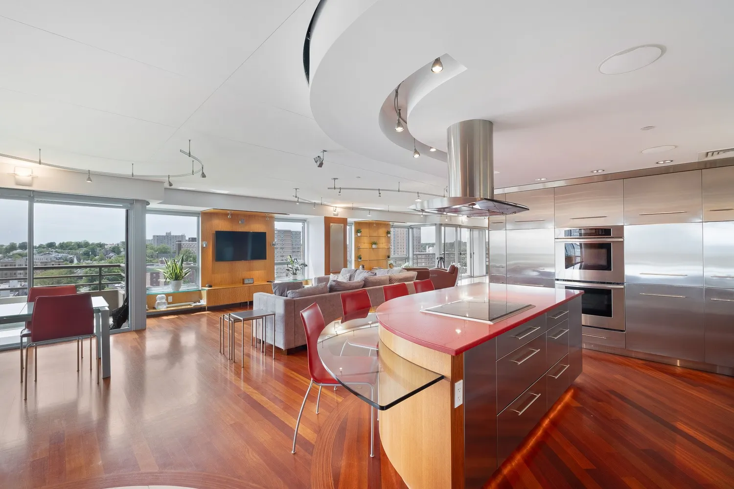 a kitchen with stainless steel appliances kitchen island granite countertop a sink and dining table view