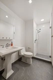 a bathroom with a sink toilet and shower