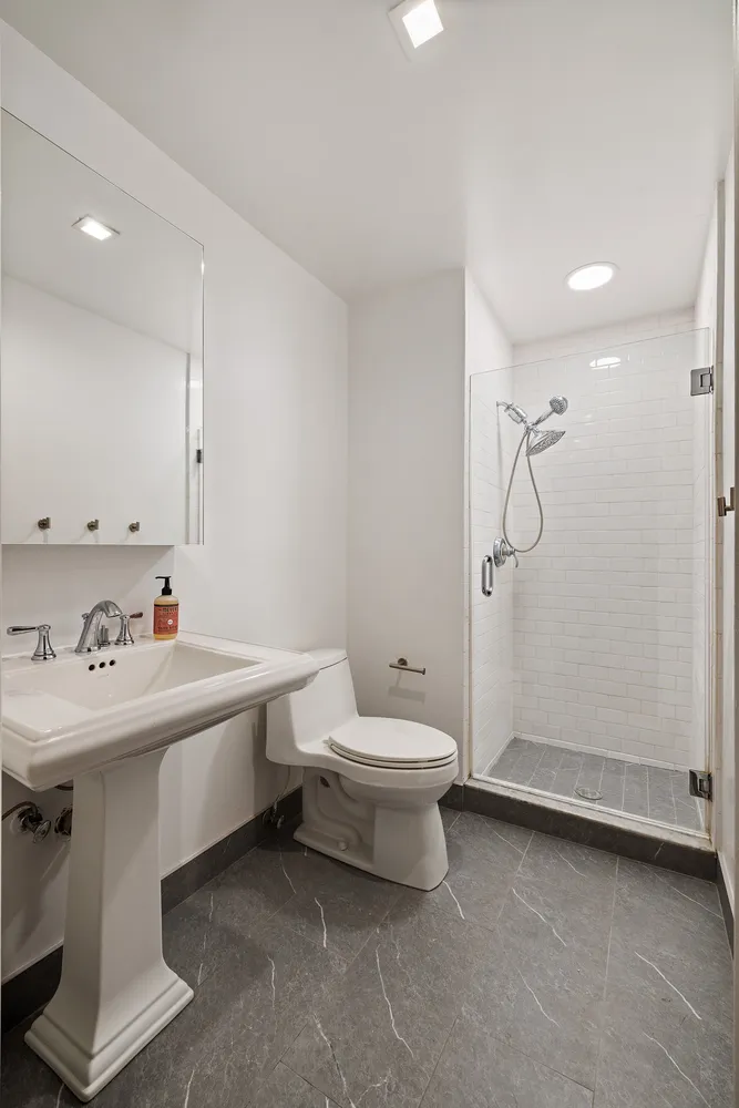 a bathroom with a sink toilet and shower