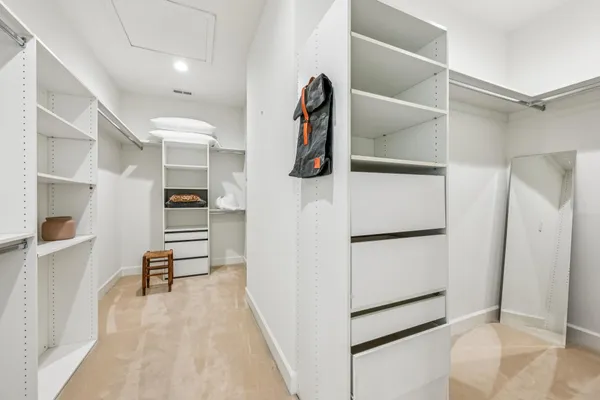 a bedroom with two beds and painting on the wall