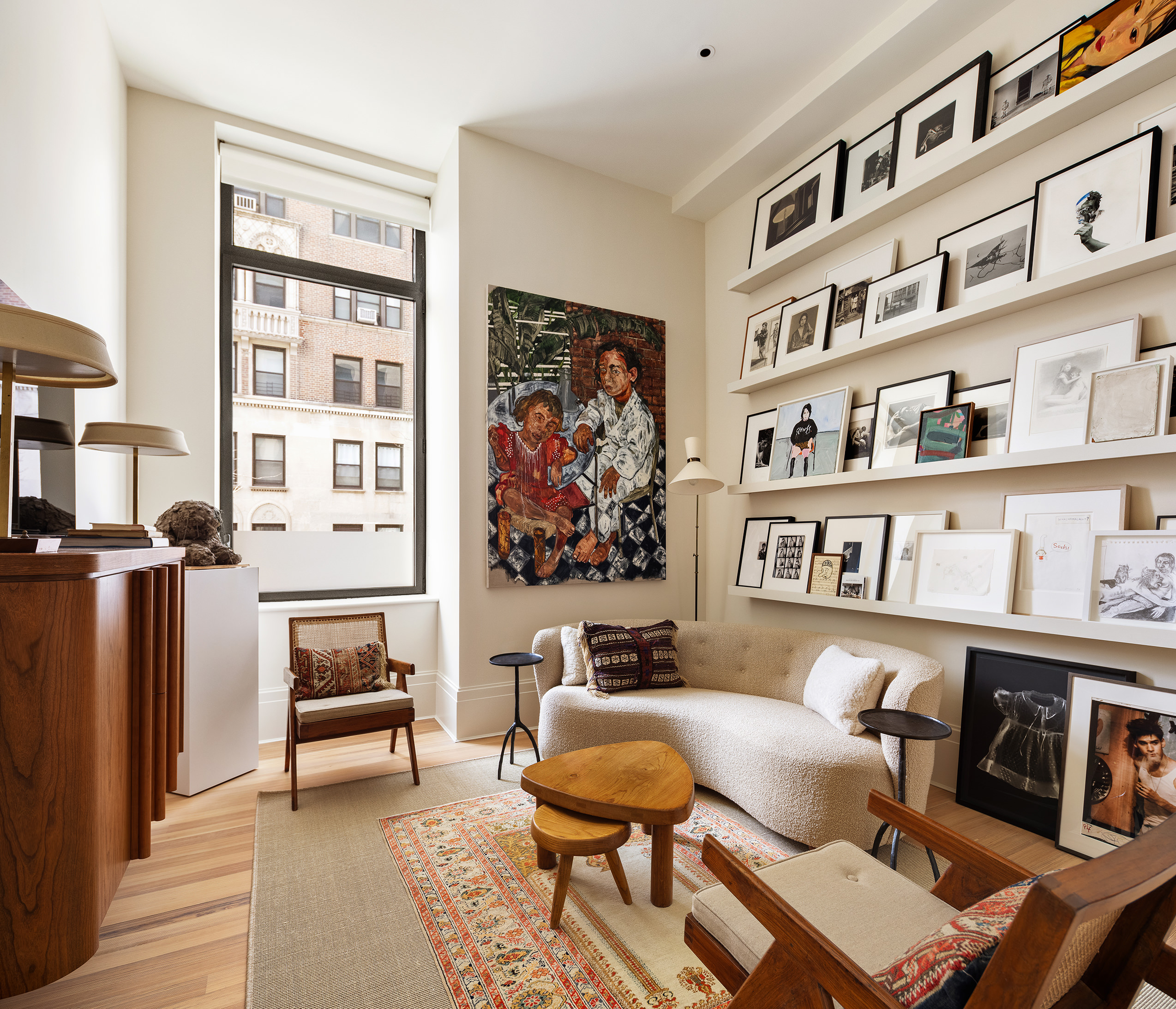 1 Prospect Park West, Unit 2B Brooklyn, NY 11215 - Photo 14 of 23 a living room with furniture a rug and a book shelf