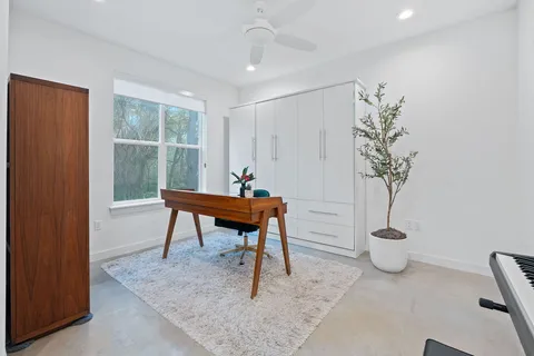 a work room with furniture and a potted plant