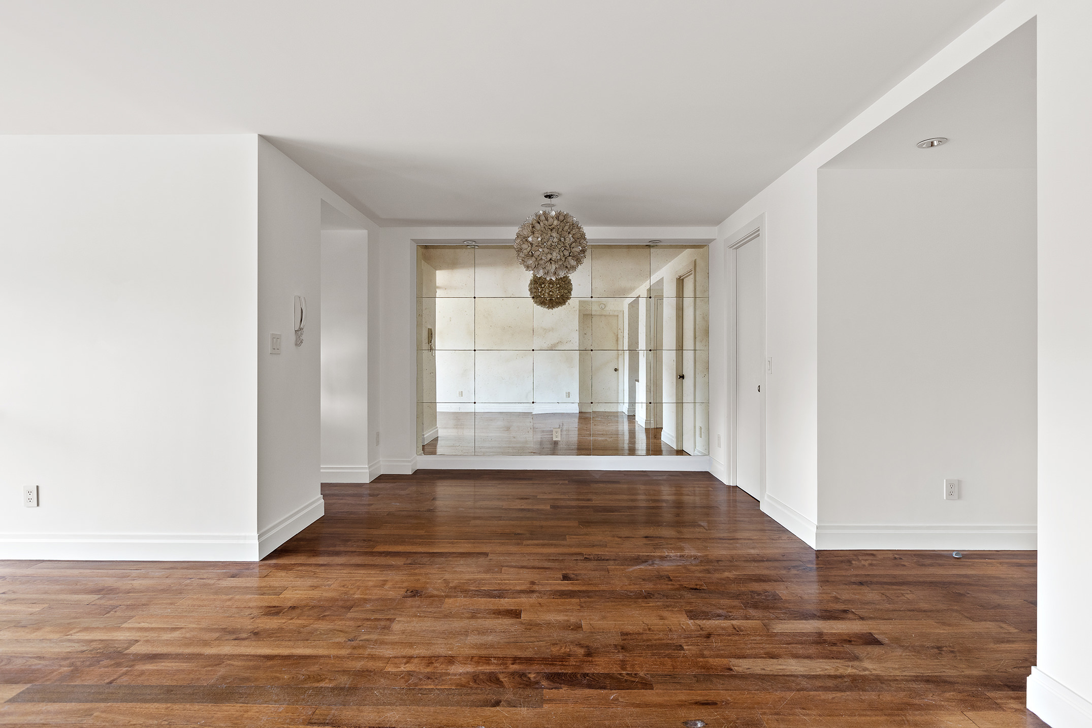 70 East 10th Street, Unit 14P Manhattan, NY 10003 - Photo 4 of 8 a view of an empty room with wooden floor and a window