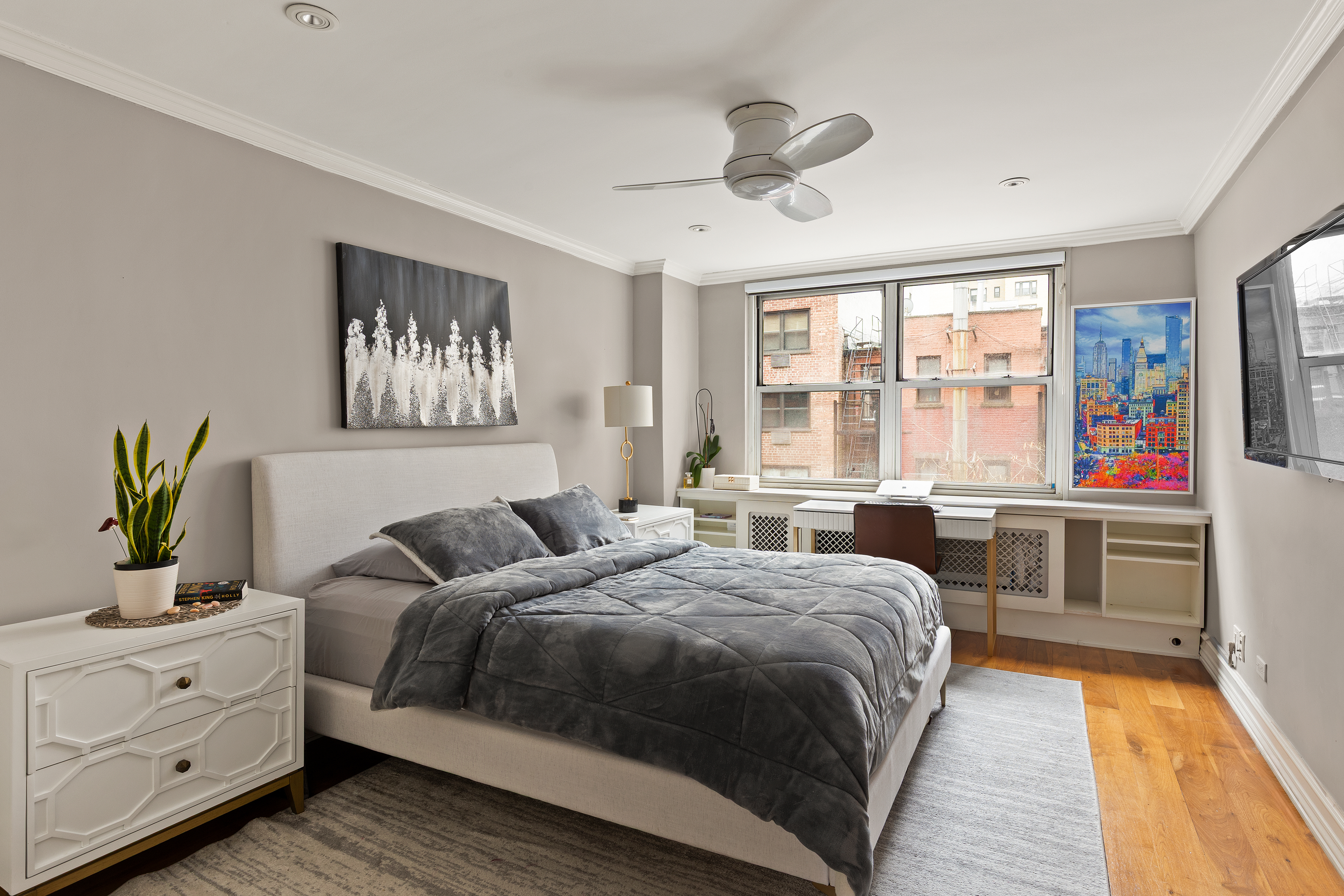 310 East 70th Street, Unit 6A Manhattan, NY 10021 - Photo 3 of 9 a bedroom with a large bed and a chandelier