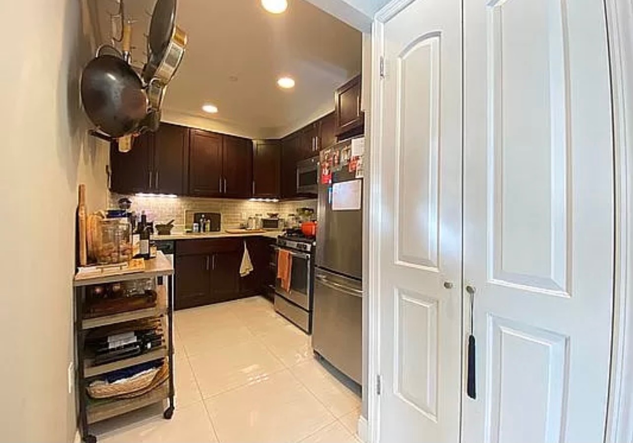 456 West 167th Street, Unit 6C Manhattan, NY 10032 - Photo 4 of 11 a kitchen with a refrigerator and a stove top oven