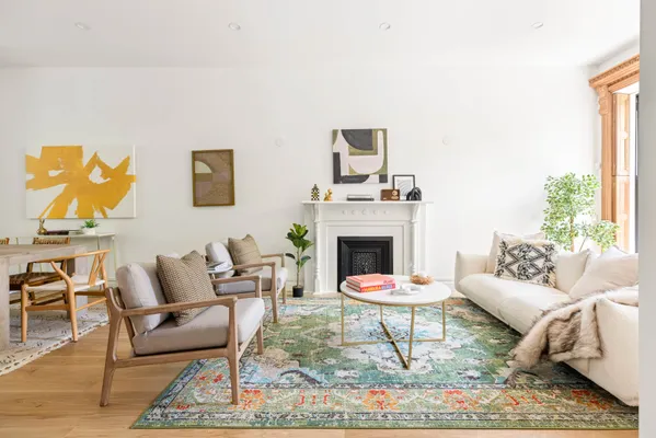 a living room with furniture a rug and a fireplace