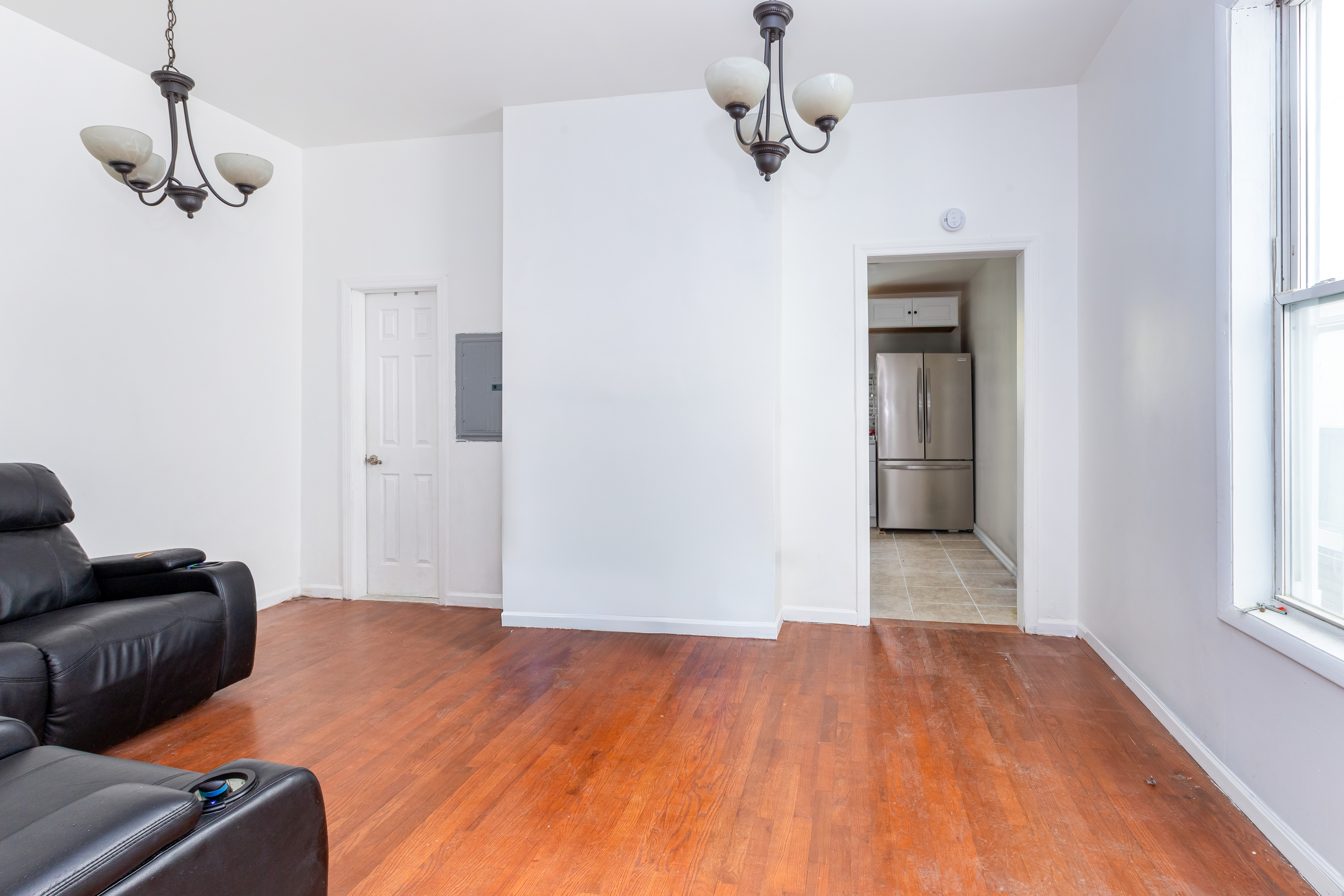 610 East 181st Street Bronx, NY 10457 - Photo 5 of 13 a bedroom with a bed and wooden floor