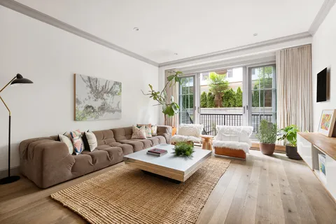 a living room with furniture and a potted plant