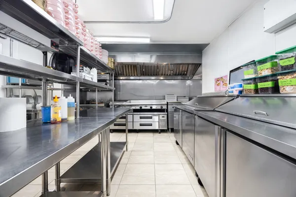a kitchen with stainless steel appliances granite countertop a sink and stove