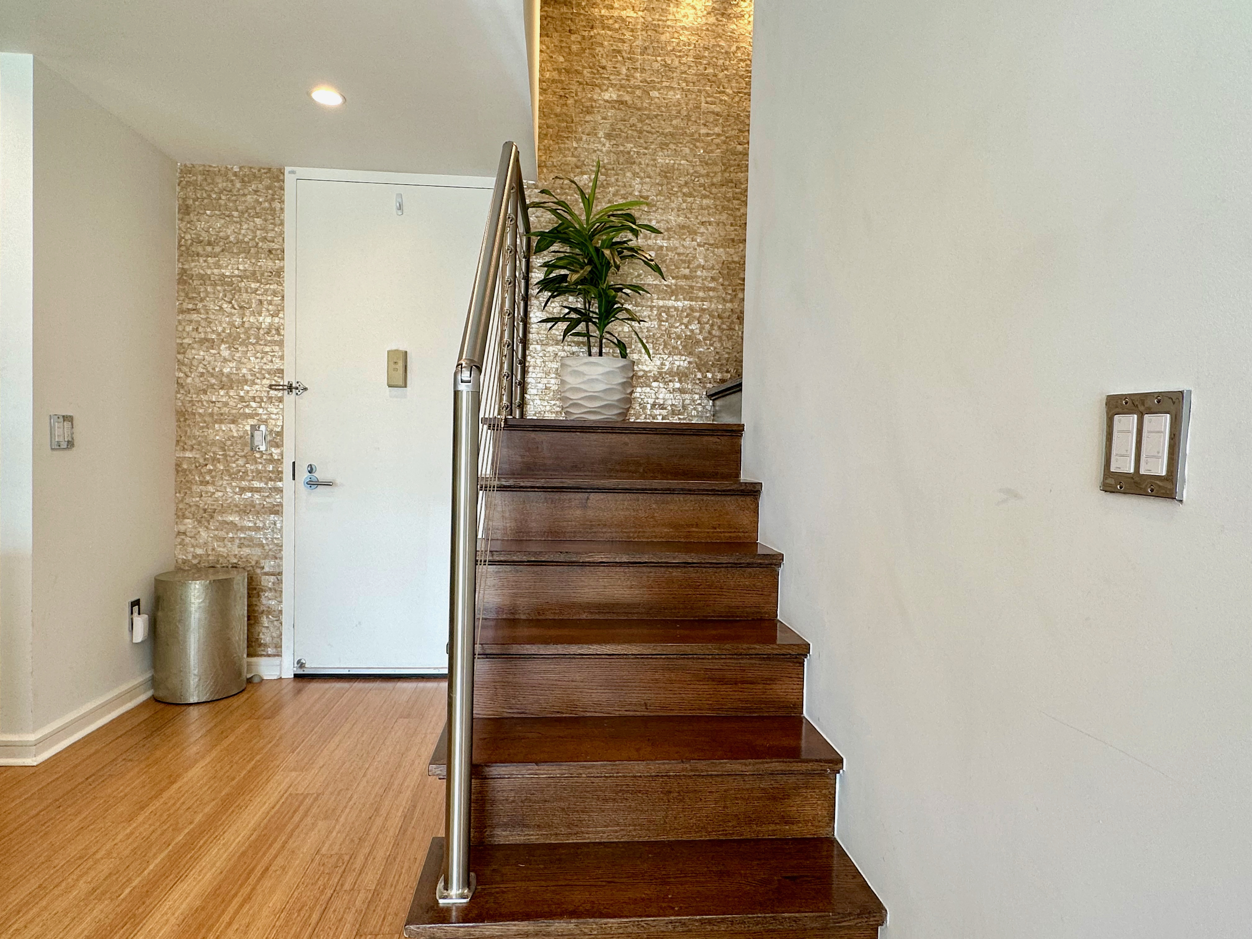 350 West 53rd Street, Unit PHA Manhattan, NY 10019 - Photo 23 of 35 a view of entryway with wooden floor and stairs