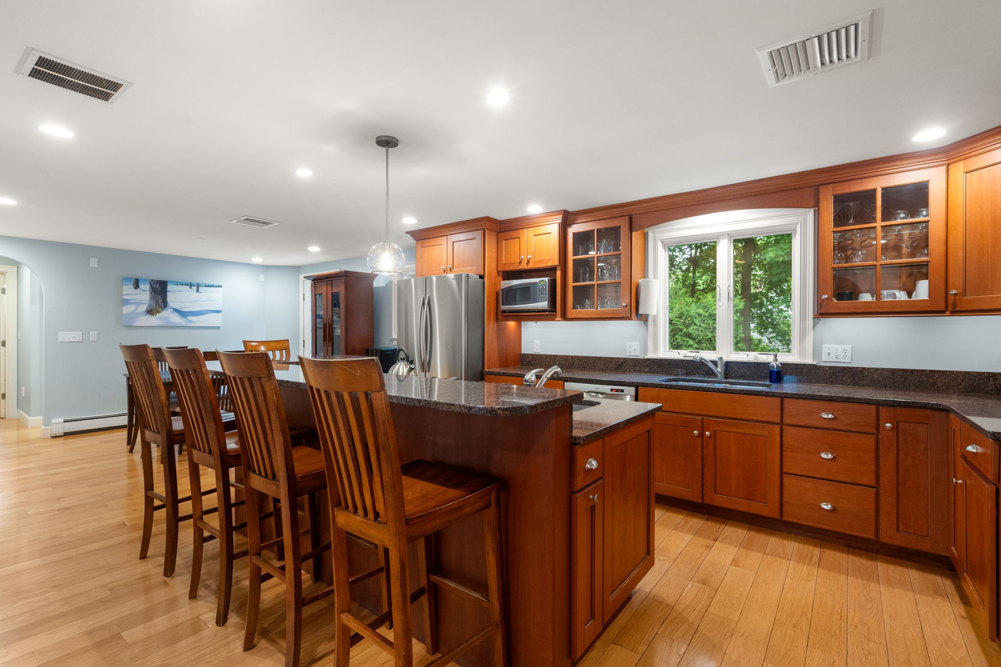 4 Gage Road Wayland, MA 01778 - Photo 7 of 32 a kitchen with stainless steel appliances granite countertop a table chairs sink and wooden floor
