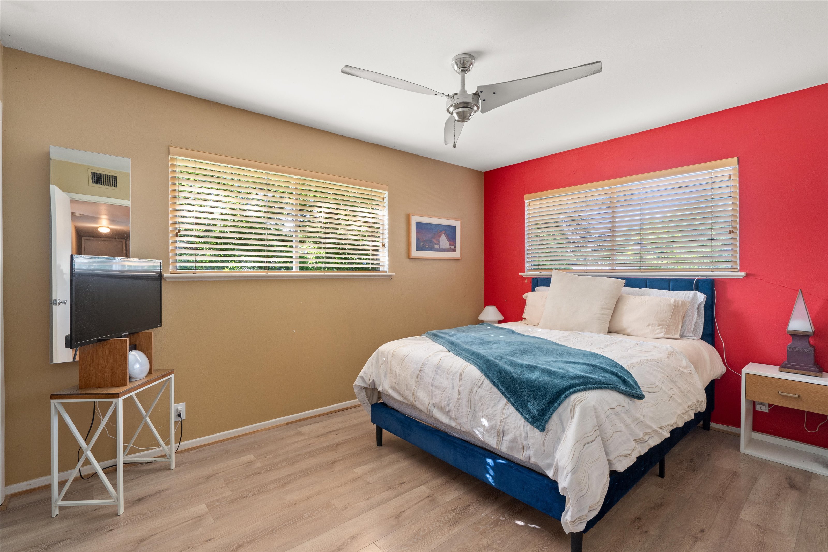 4614 Jinx Avenue Austin, TX 78745 - Photo 13 of 40 a bedroom with a bed a chair and a chandelier
