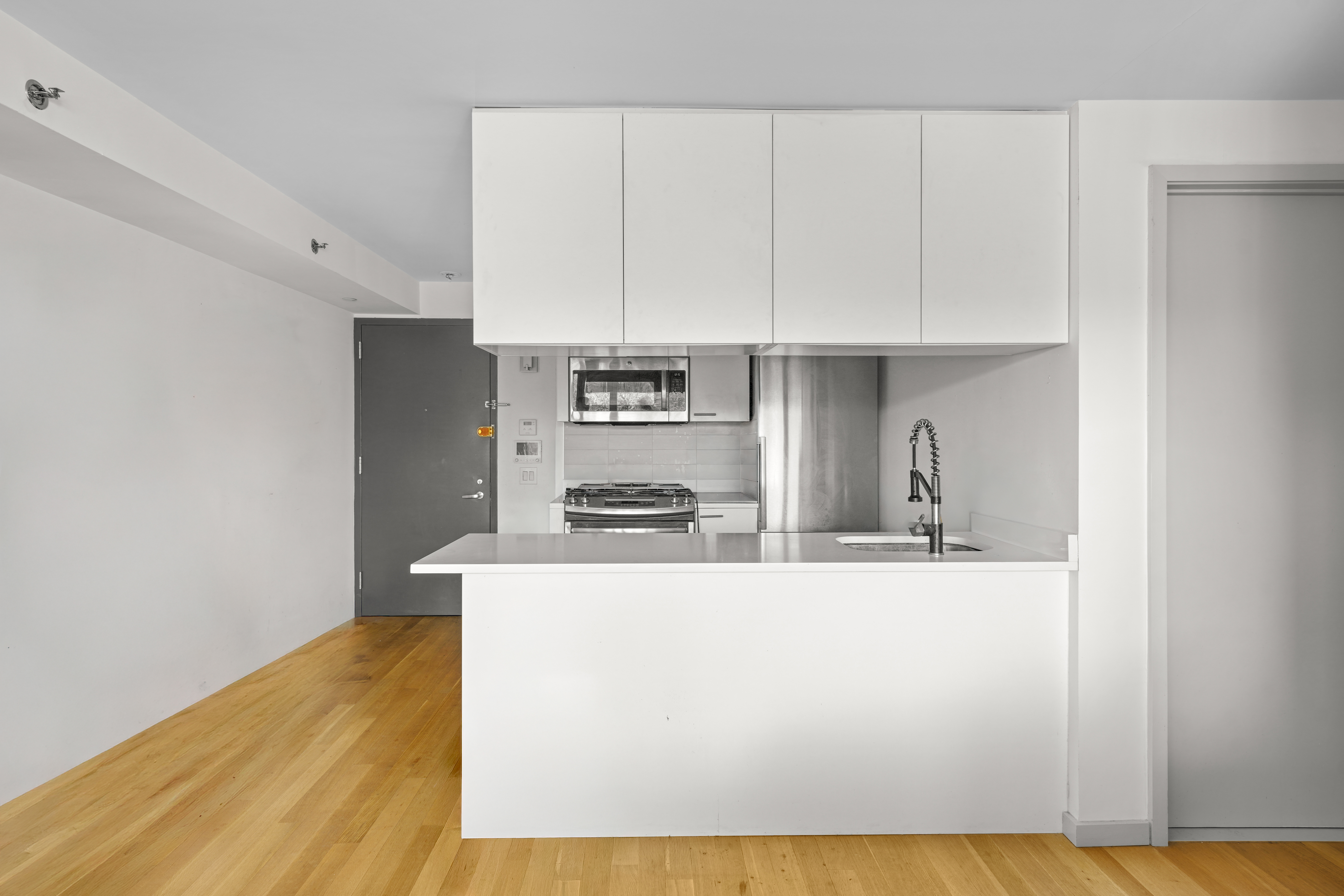 448 West 167th Street, Unit 3E Manhattan, NY 10032 - Photo 9 of 24 a kitchen with stainless steel appliances a sink a stove a refrigerator and cabinets