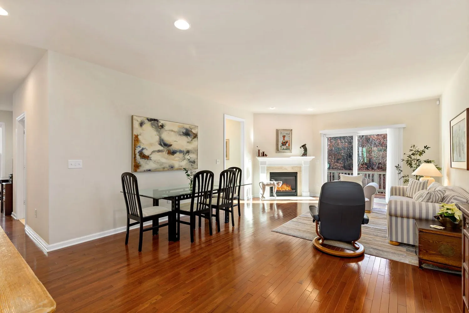 a dining room with furniture window and wooden floor